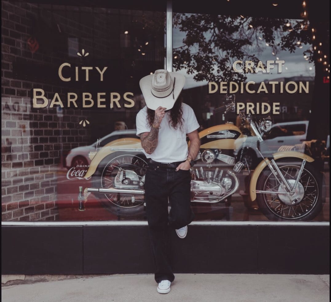 Ace standing outside the City Barbers storefront in Downtown Salt Lake City