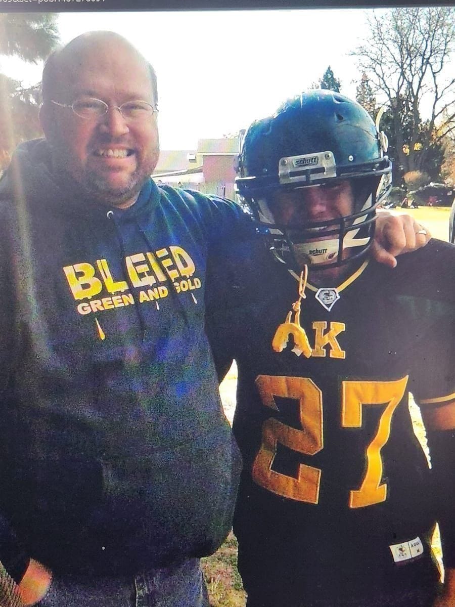 Matthew and his father at a football game