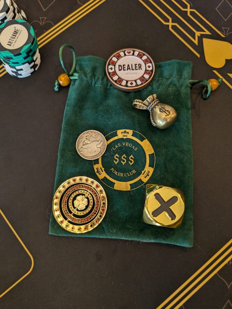 Poker chips, dealer button, and card guards won at a Gentleman's Game night