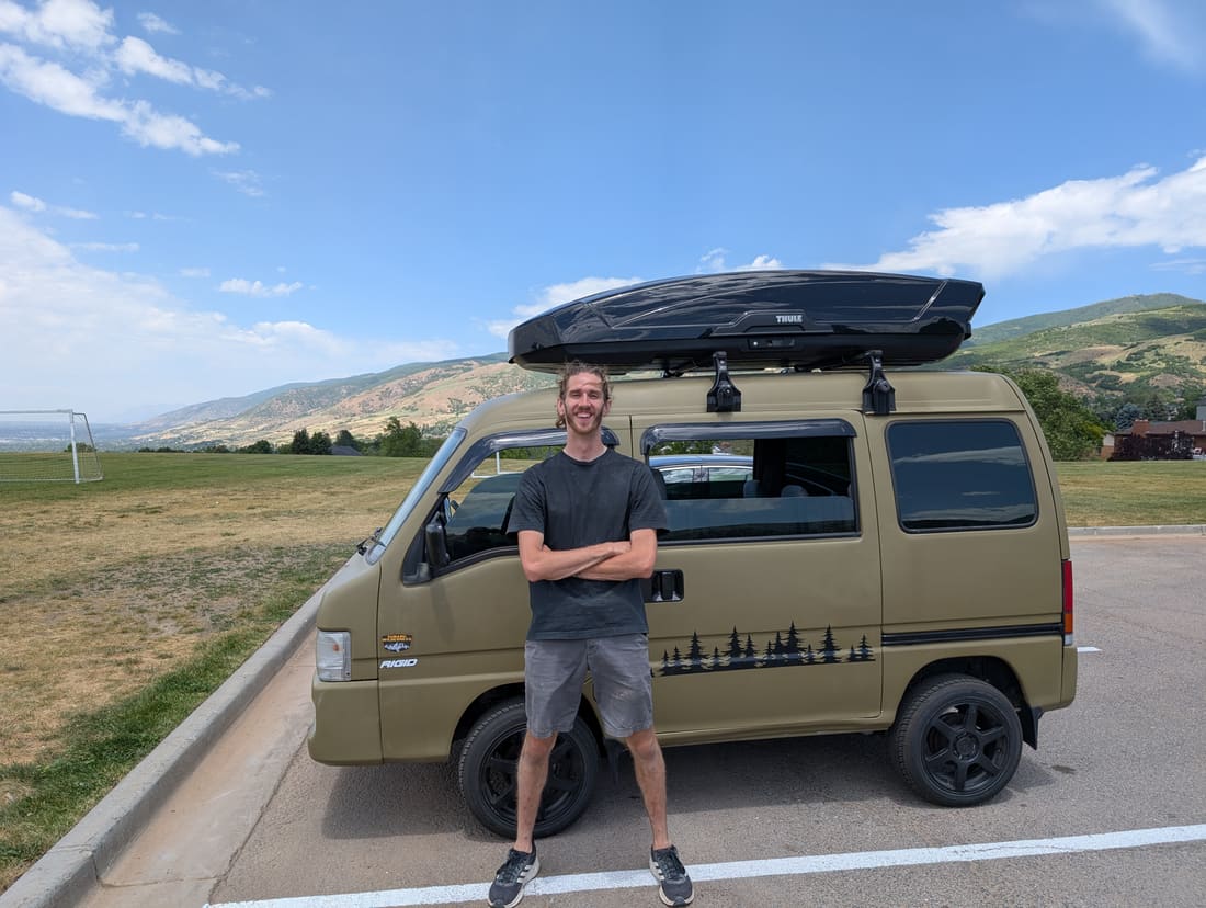 Tyler High standing in front of the olive-green High Bj&ouml;rn work van