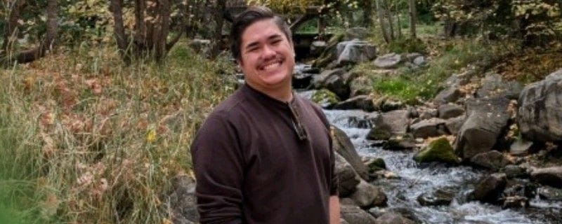 Matthew by a stream in the Utah mountains