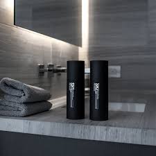 Two Patrick's product bottles on a bathroom counter
